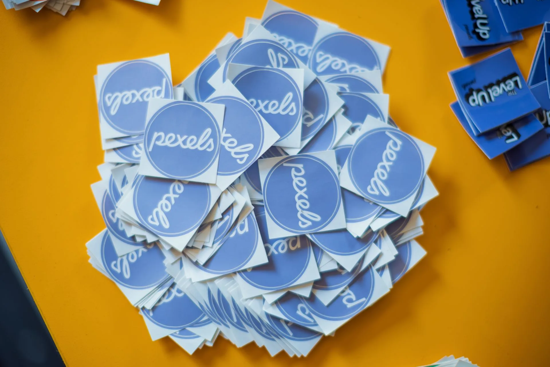 A printed die-cut sticker held in the frame against a plain background